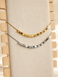 Cube bead spinner necklace with 18K gold plating and a non-tarnish finish.