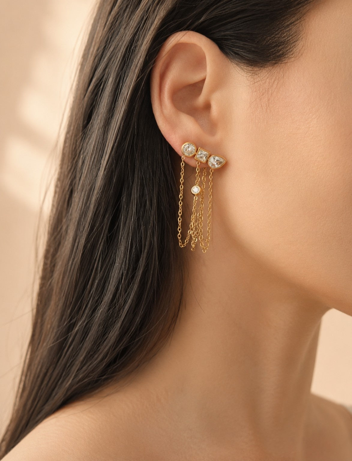 Geometric chain drop earrings with sparkling cubic zirconia stones and an 18K gold-plated stainless steel base.