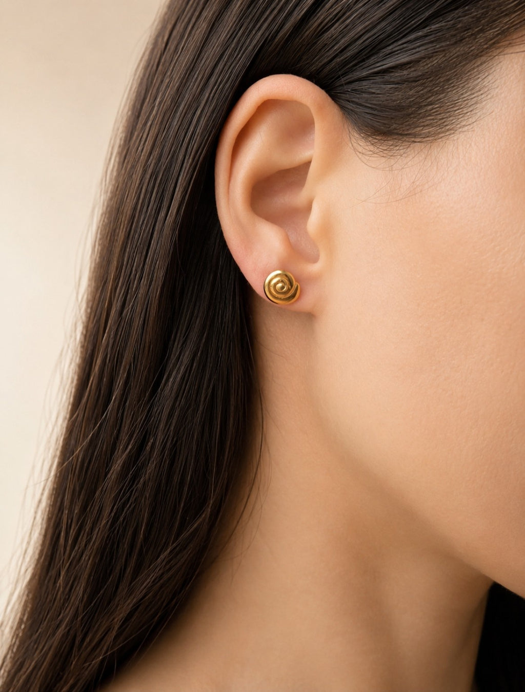 Spiral earrings with an 18K gold-plated finish inspired by a snail shell.