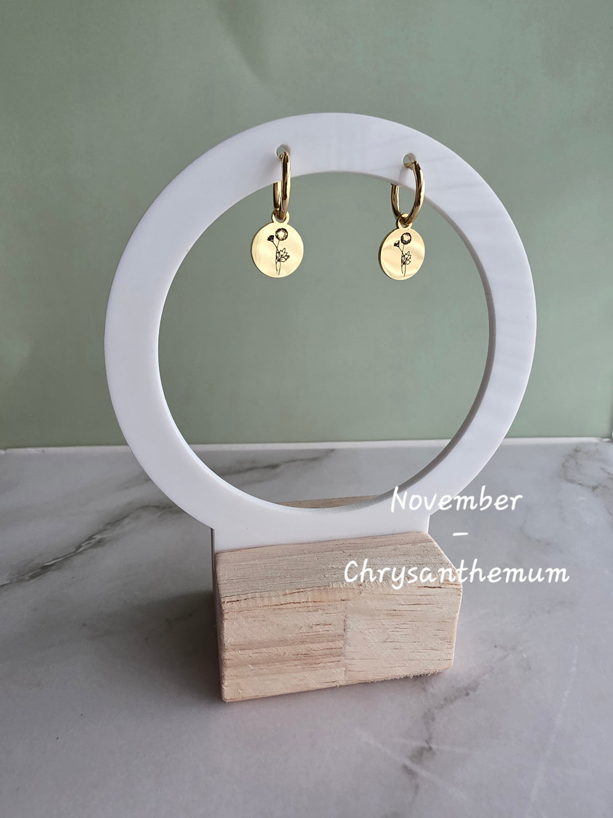 Timeless birth flower huggie hoop earrings in 18K gold plating, perfect for everyday wear and thoughtful gifts.