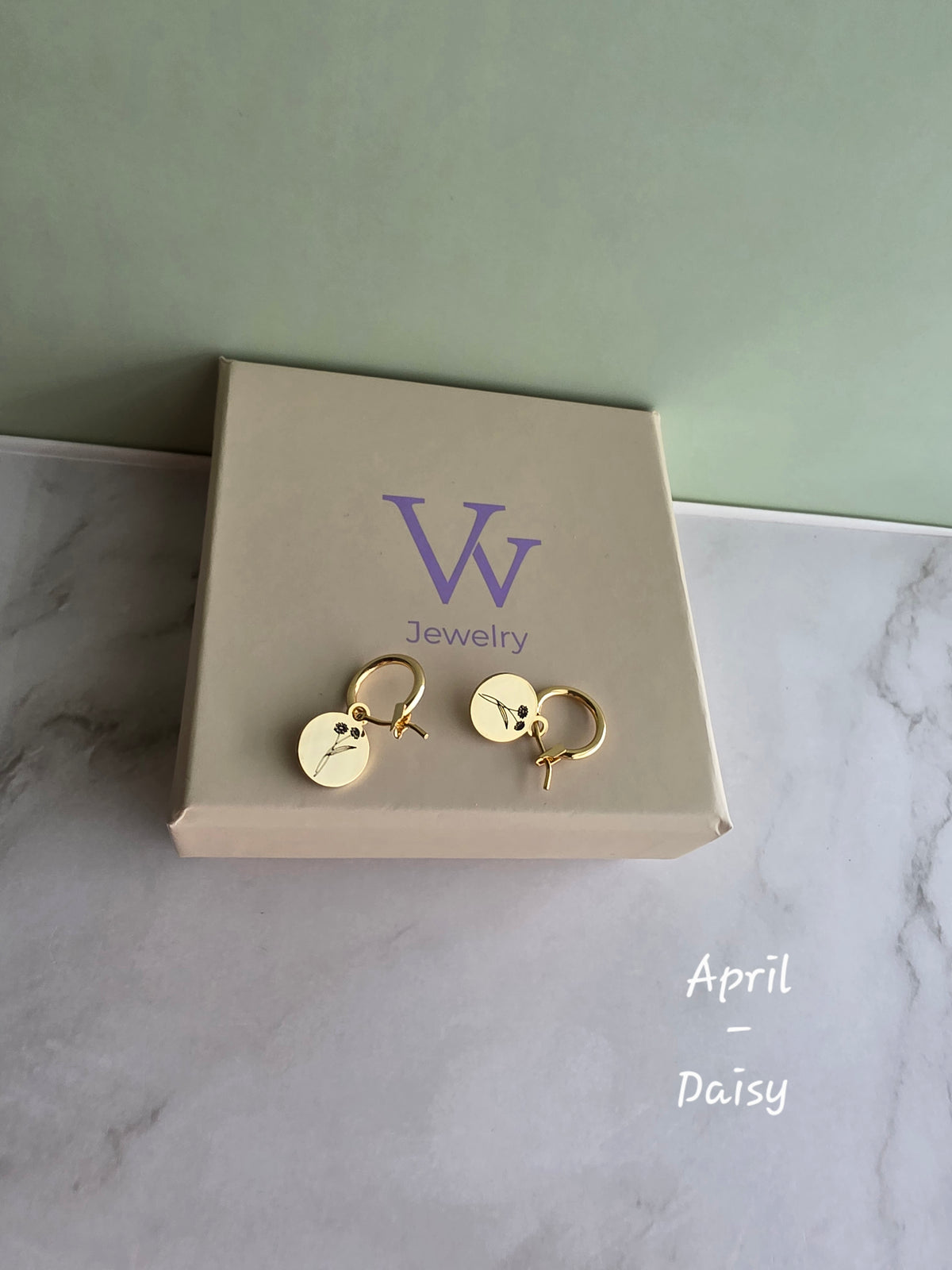Botanical birth flower earrings crafted with 18K gold-plated huggie hoops.