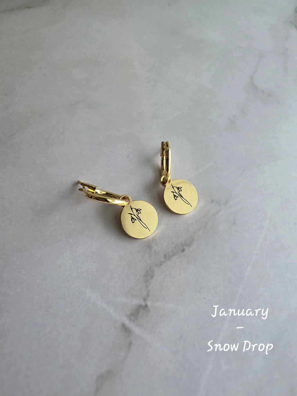 Elegant birth flower huggie earrings with engraved floral charms for women.