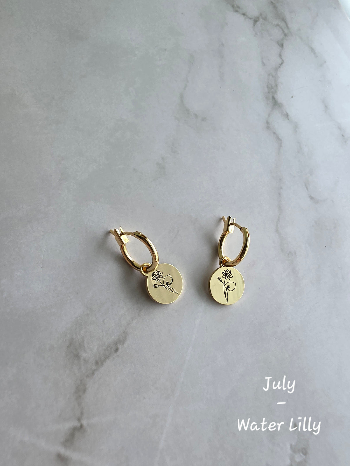 Elegant birth flower charm earrings with lightweight gold-plated huggie hoops.
