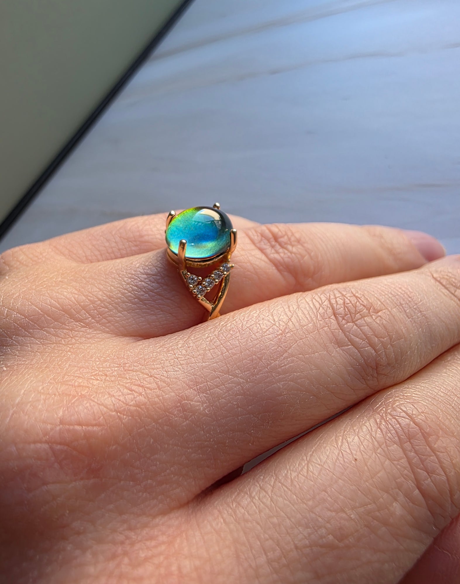 Women's chunky mood ring designed with a smooth gold-plated adjustable setting.
