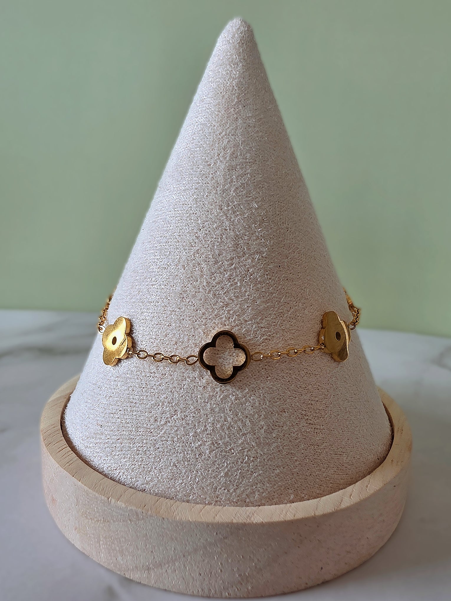 Dainty gold clover bracelet with an adjustable chain for everyday wear.