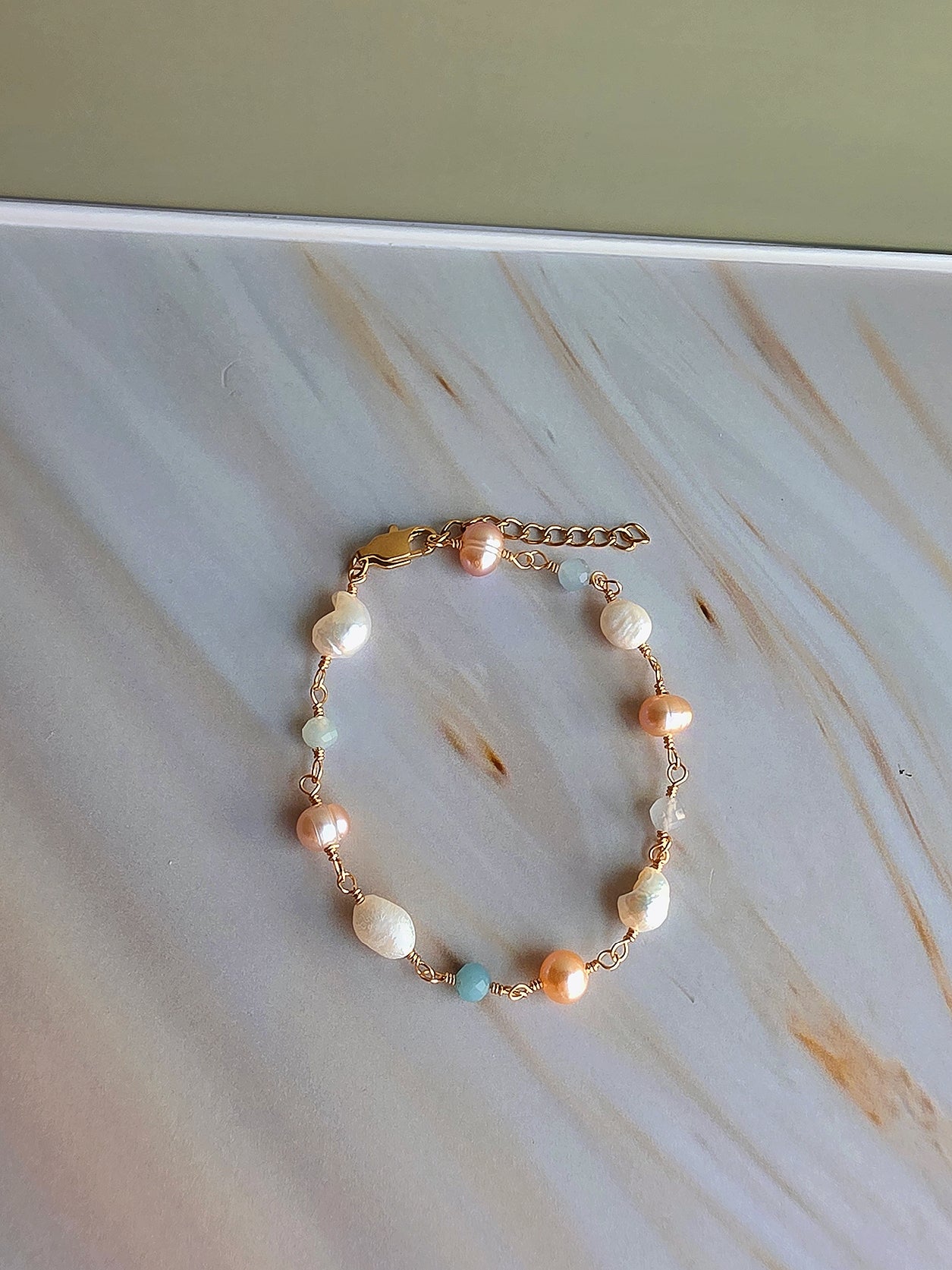 Natural freshwater pearl bracelet accented with aquamarine beads and gold details.