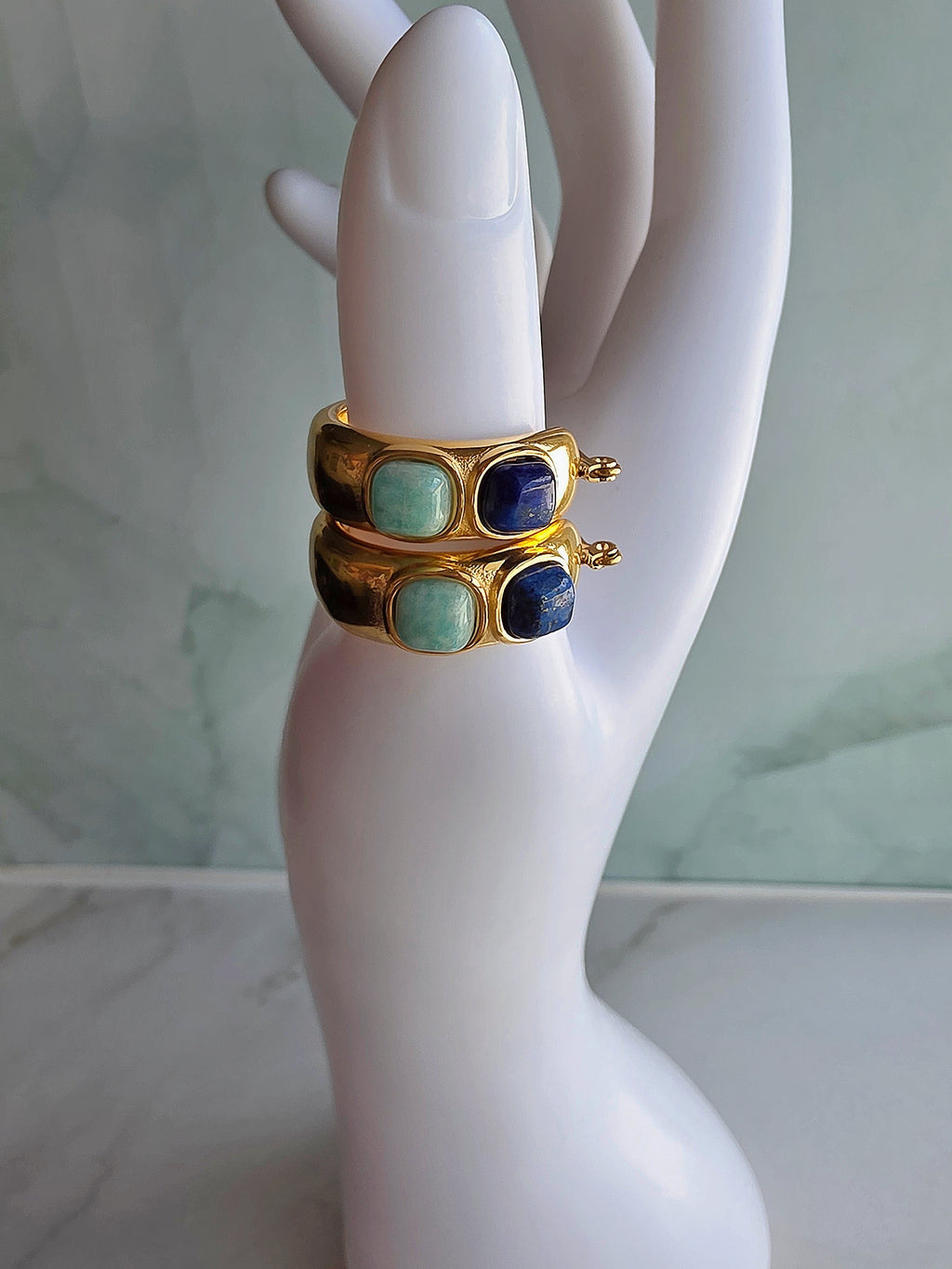 Elegant 14K gold-plated statement earrings featuring lapis lazuli stones.