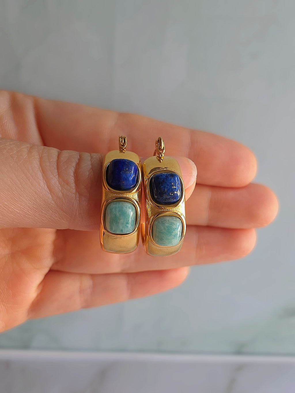 Chunky turquoise and lapis lazuli hoop earrings with a polished gold finish.