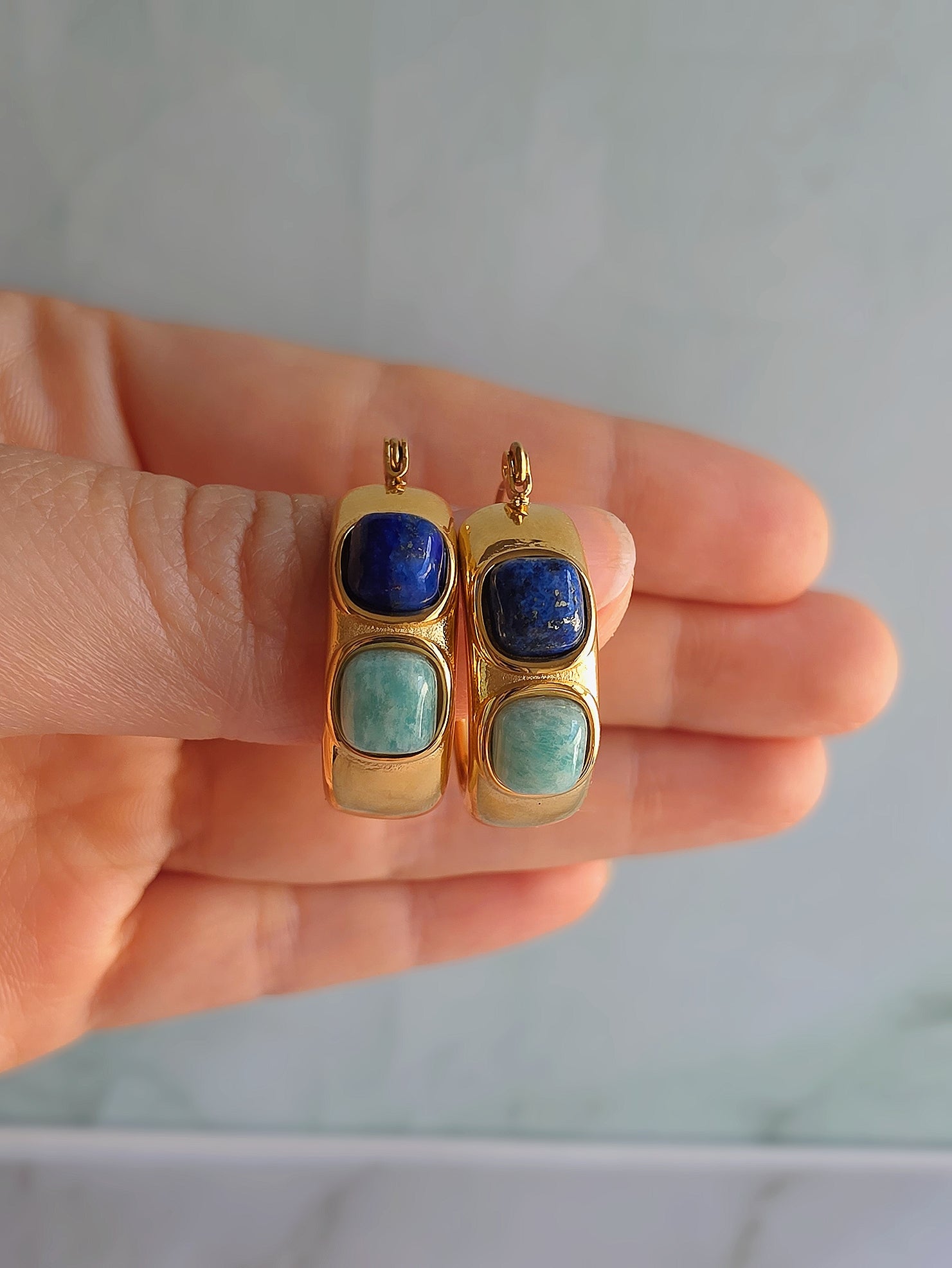 Chunky turquoise and lapis lazuli hoop earrings with a polished gold finish.