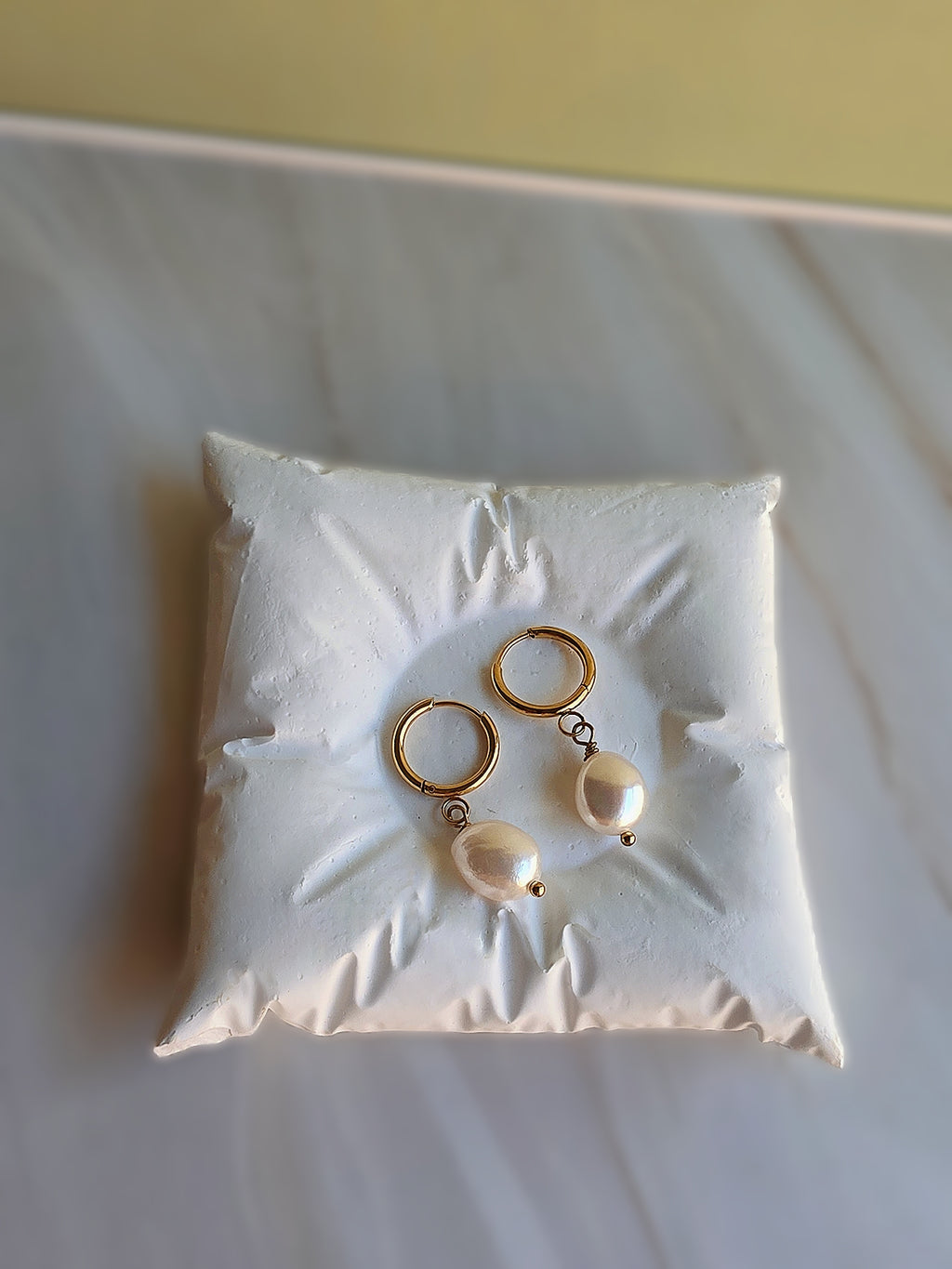 Dainty baroque pearl earrings with a timeless gold-plated design.