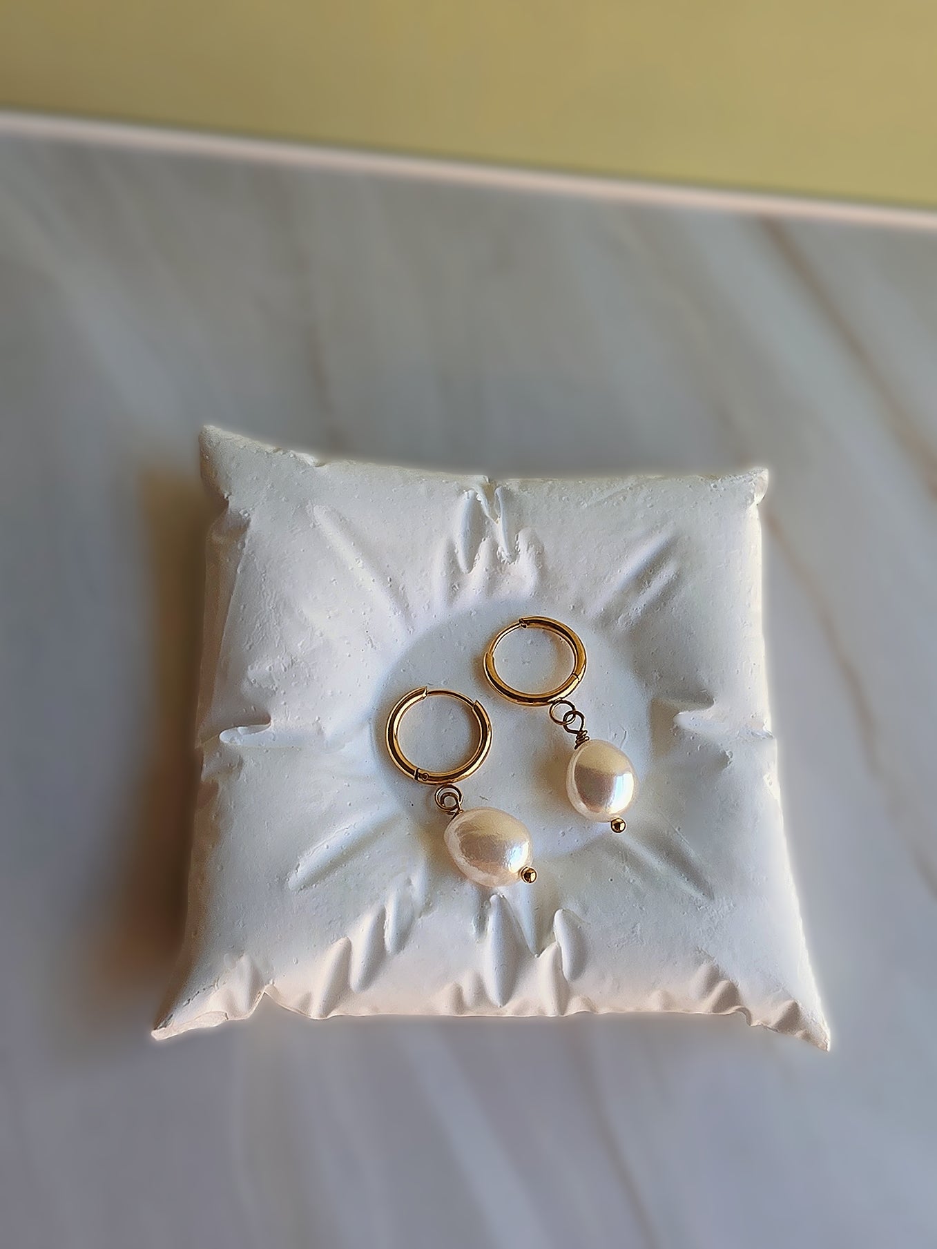Dainty baroque pearl earrings with a timeless gold-plated design.