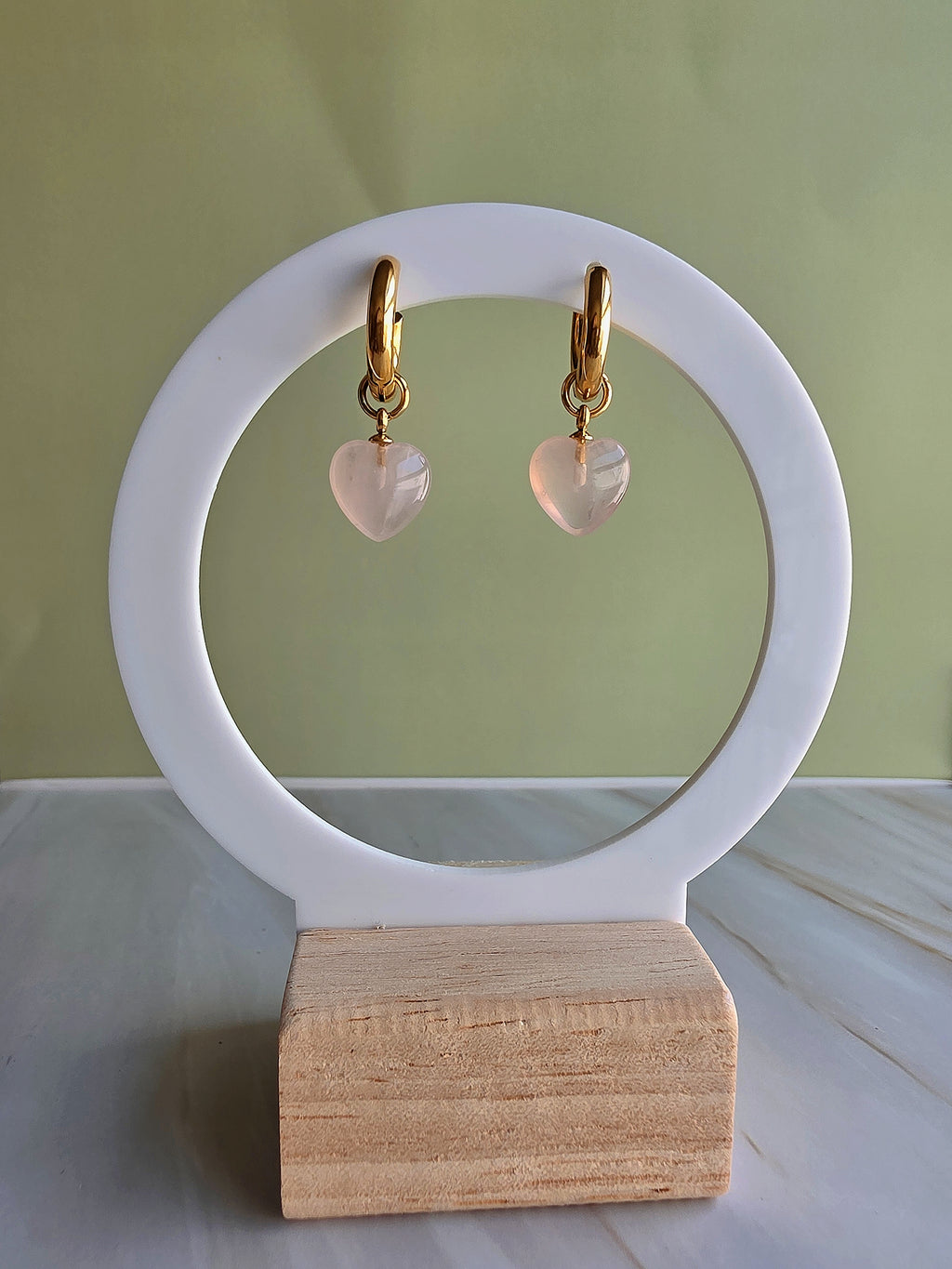 Gold-plated heart drop earrings featuring genuine rose quartz gemstones.