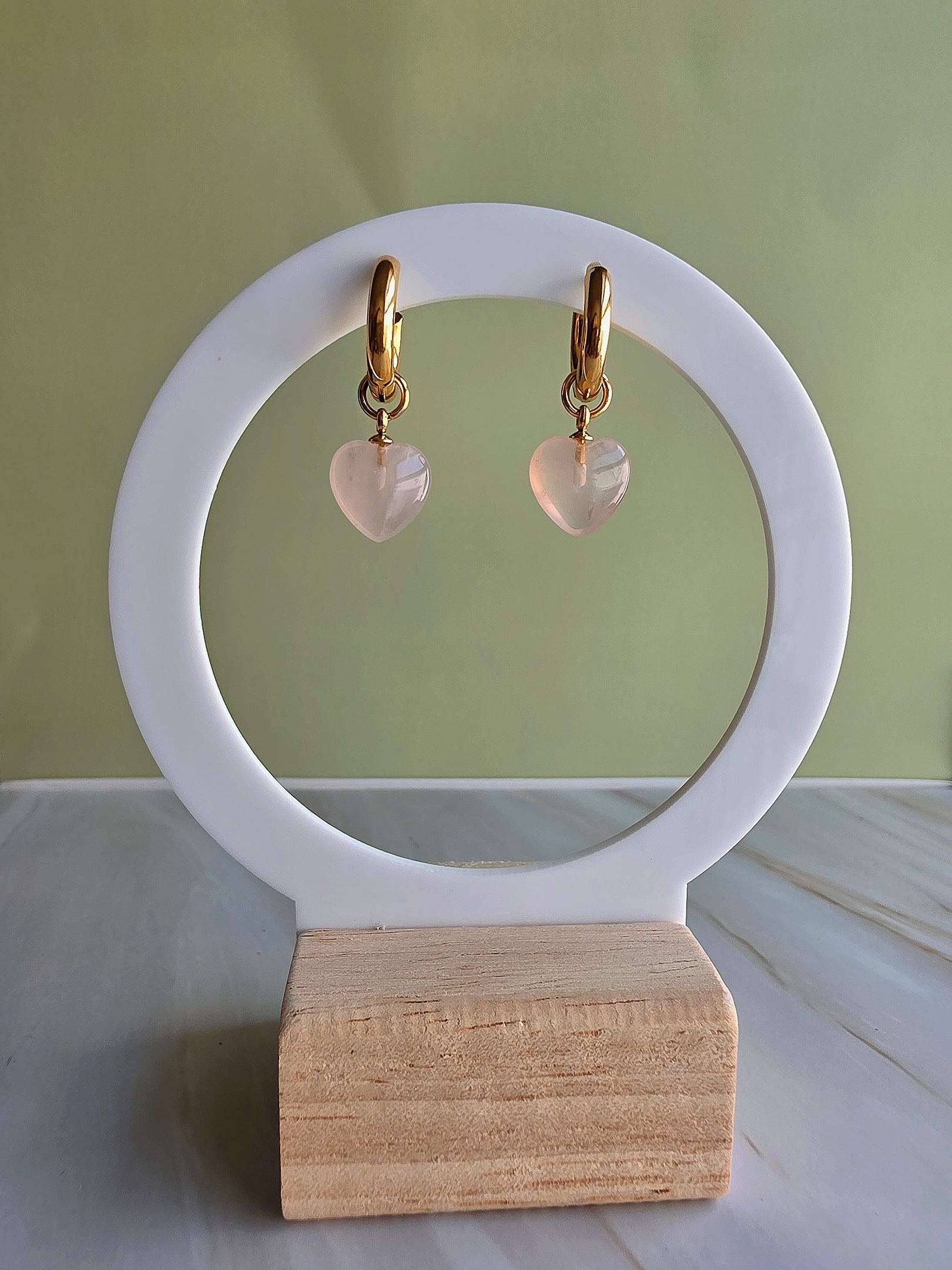 Gold-plated heart drop earrings featuring genuine rose quartz gemstones.
