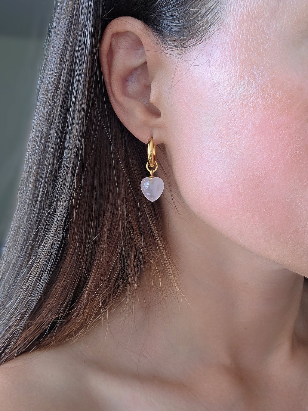 Pink heart gemstone hoop earrings featuring natural rose quartz and gold-plated hoops.