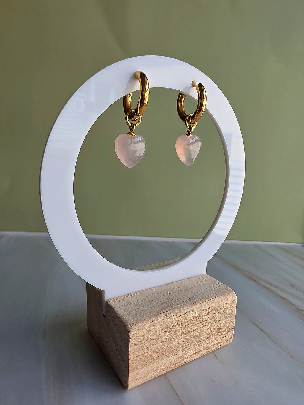 Romantic heart-shaped rose quartz earrings with polished 18K gold plating.