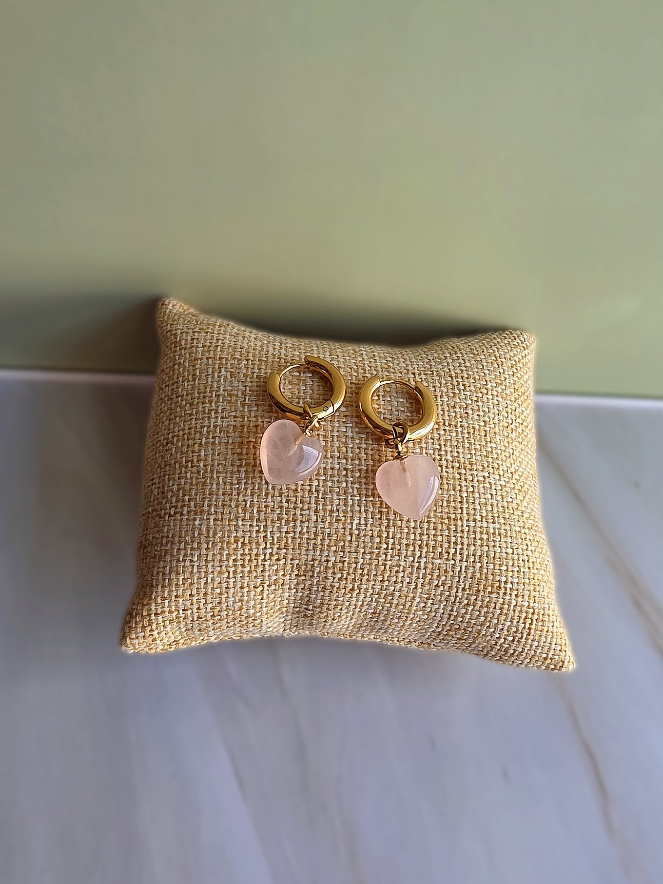 Women's rose quartz heart hoop earrings with an elegant non-tarnish finish.