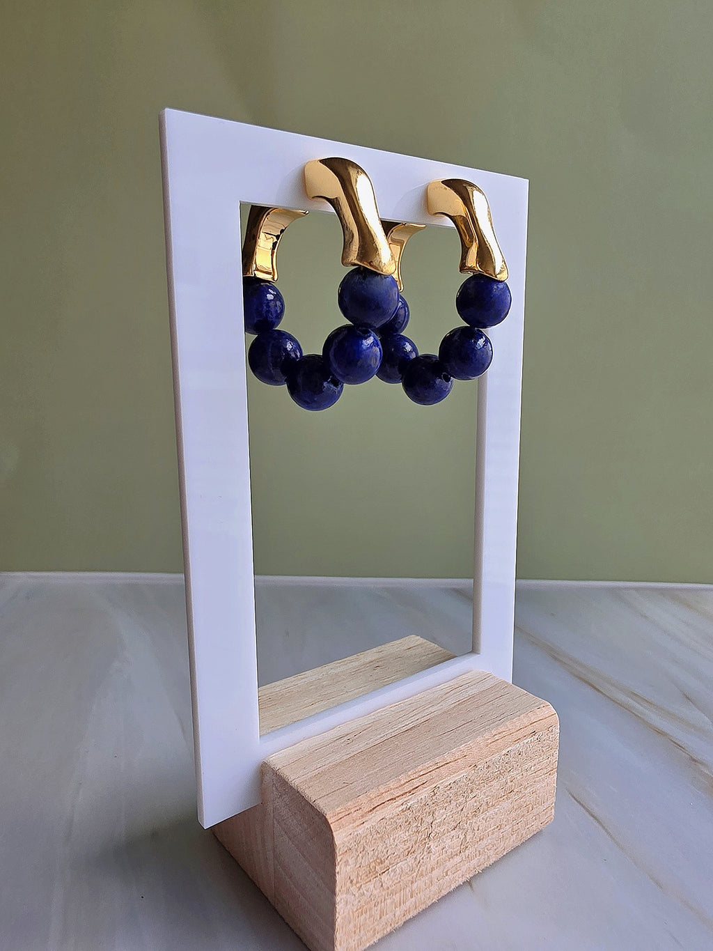 Deep blue lapis lazuli gemstone hoop earrings with a vintage-inspired design.
