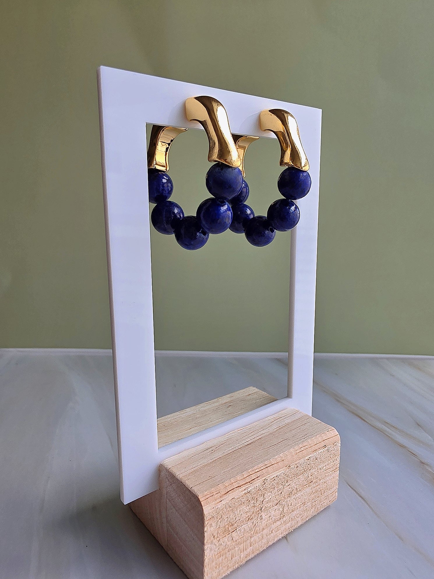 Deep blue lapis lazuli gemstone hoop earrings with a vintage-inspired design.