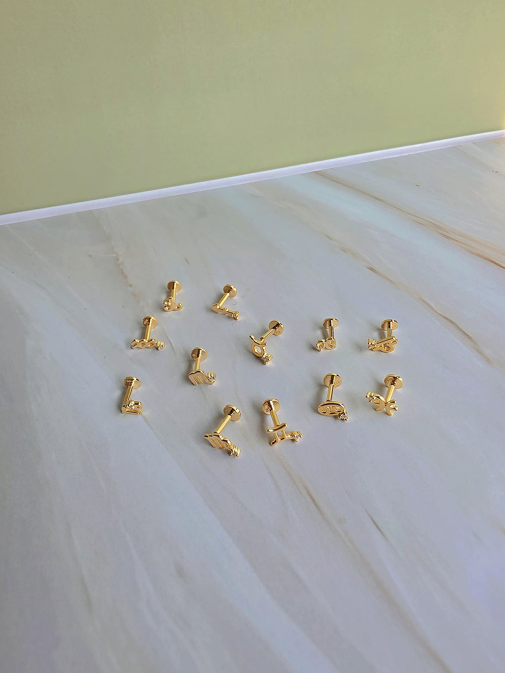 Gold-plated zodiac constellation flat back earring for cartilage piercings.