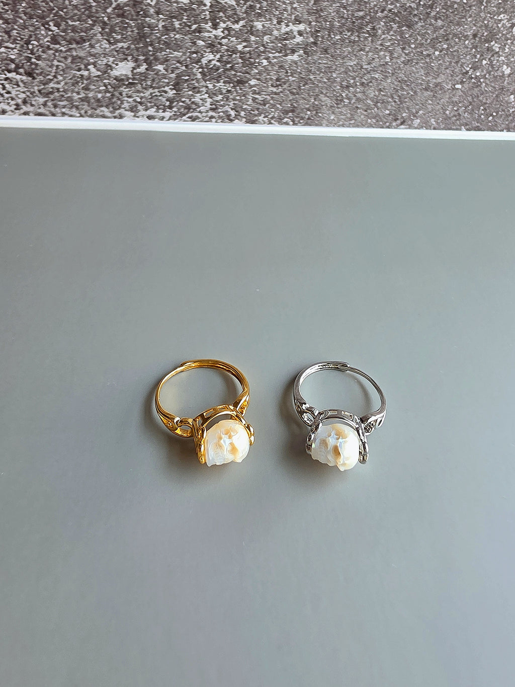 Adjustable freshwater pearl skull ring in gold finish.