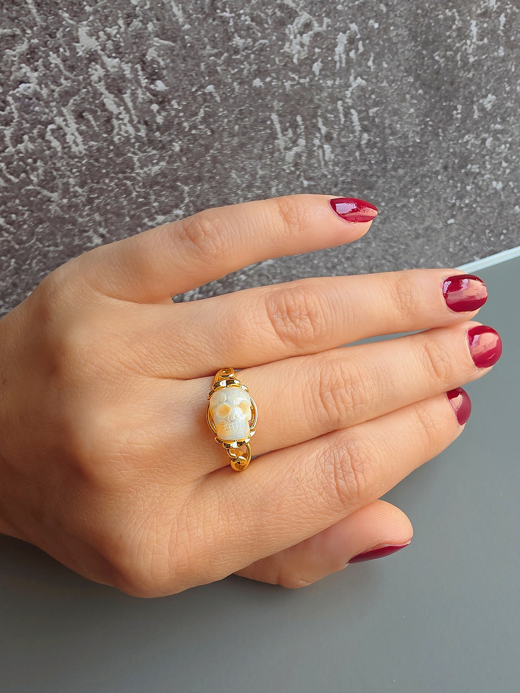 Freshwater pearl skull ring available in gold and silver.