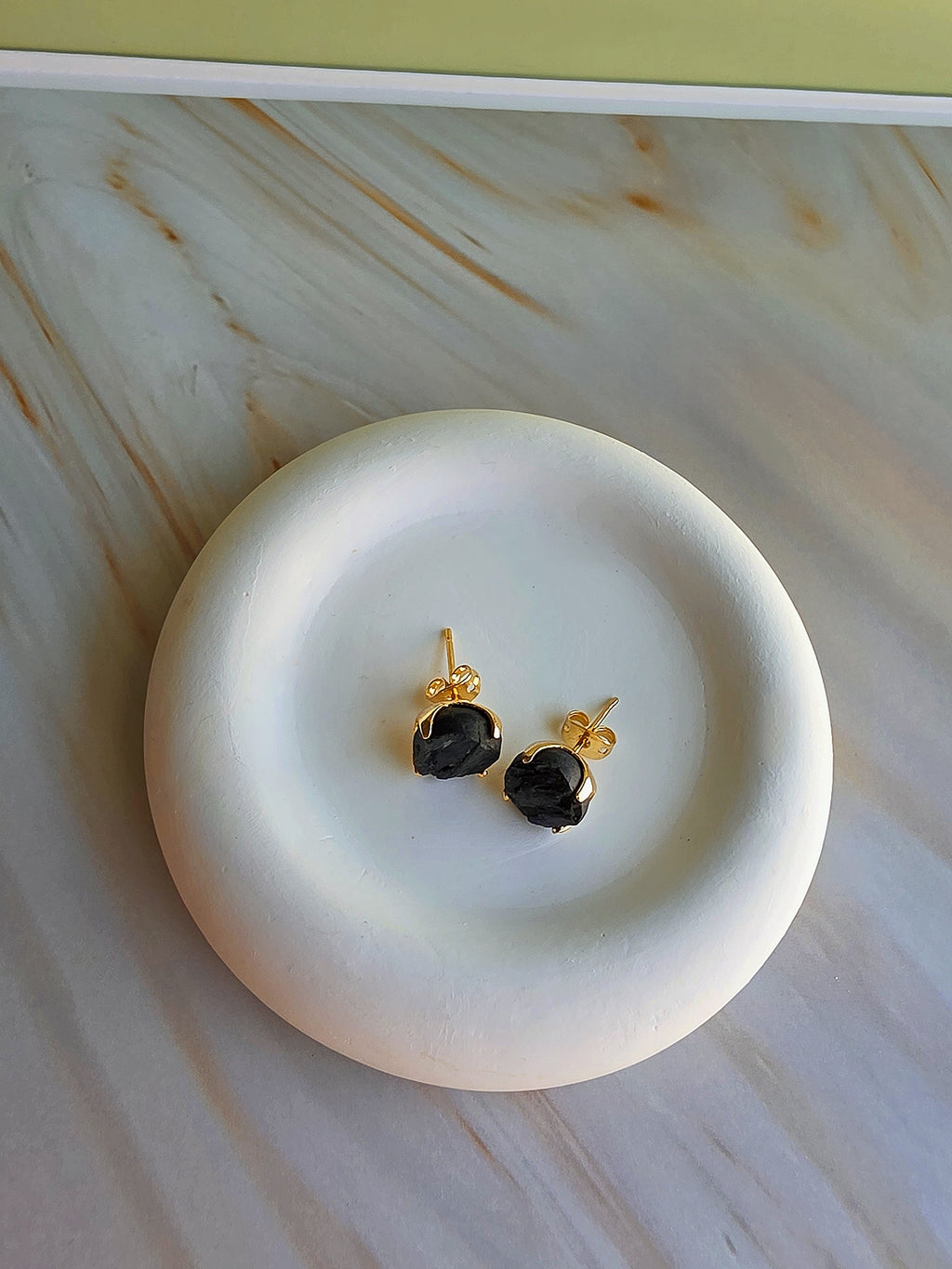 Minimalist black tourmaline earrings with a polished gold-plated finish.