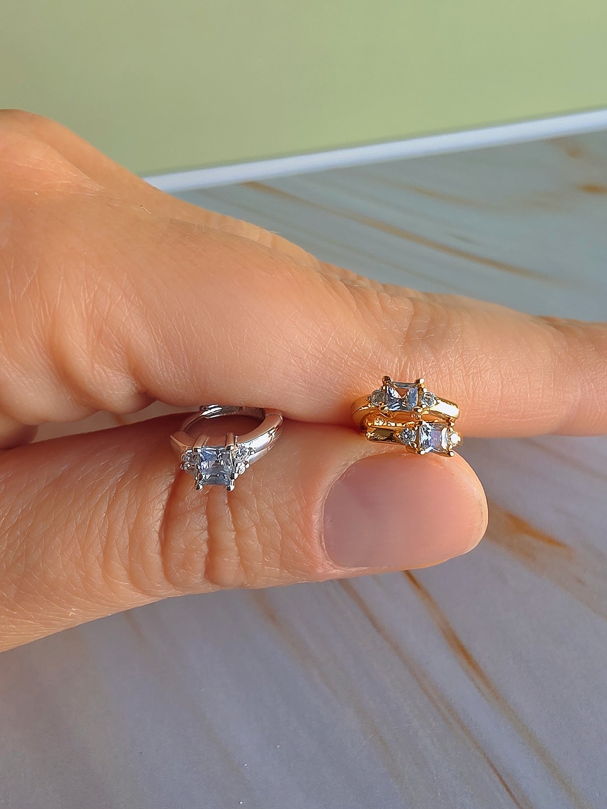 Elegant gold-plated huggie hoop earrings featuring genuine aquamarine gemstones.