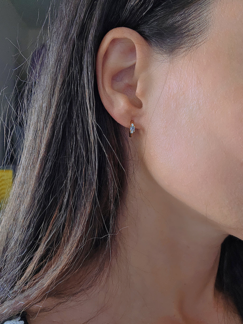 Delicate aquamarine huggie hoops with sparkling blue natural stones.