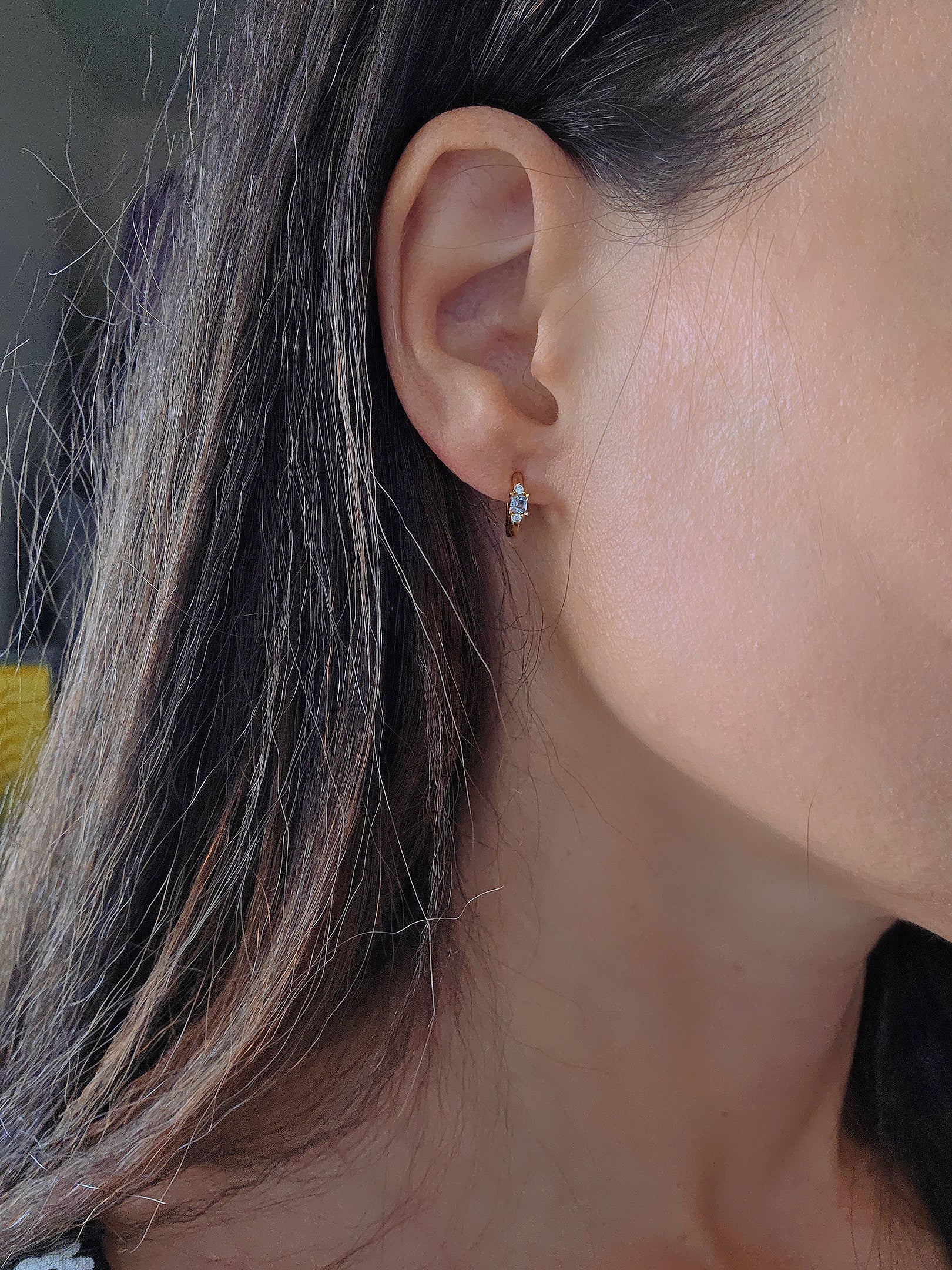 Delicate aquamarine huggie hoops with sparkling blue natural stones.