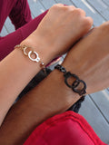 Matching handcuff bracelets for couples made from non-tarnish stainless steel.