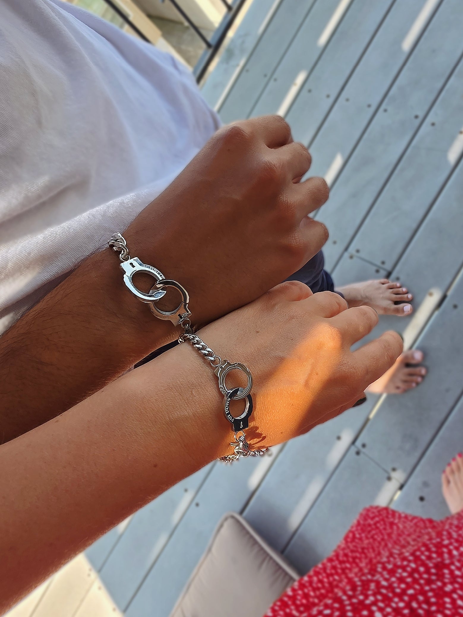 Polished handcuff bracelet set crafted from non-tarnish stainless steel.