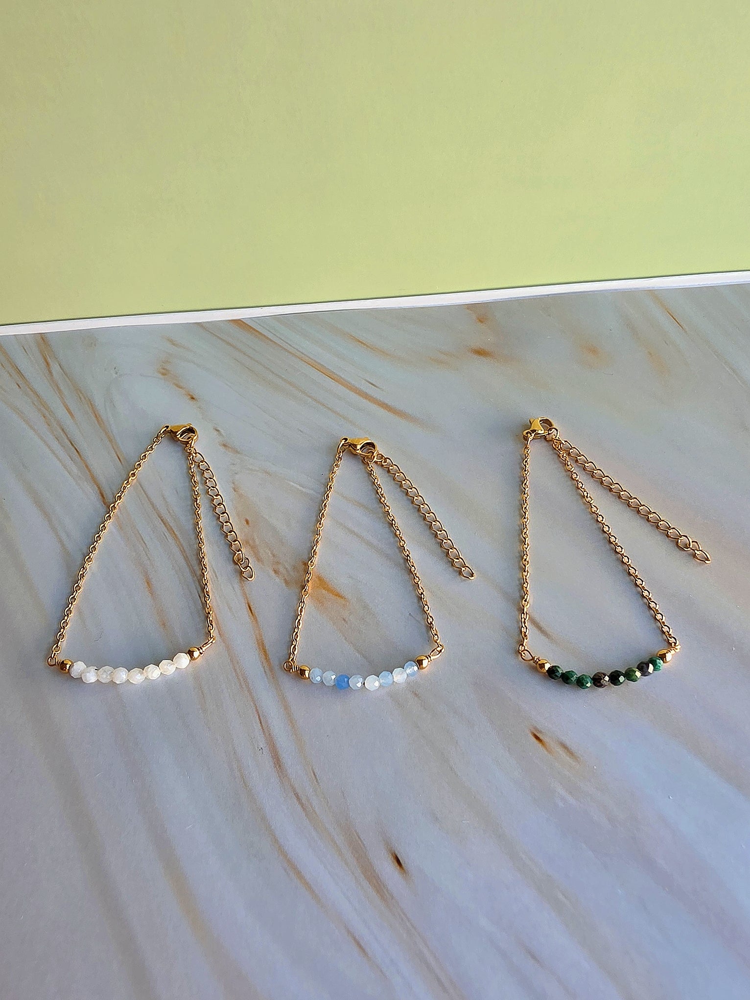 18K gold-plated adjustable bracelet with aquamarine gemstone beads.