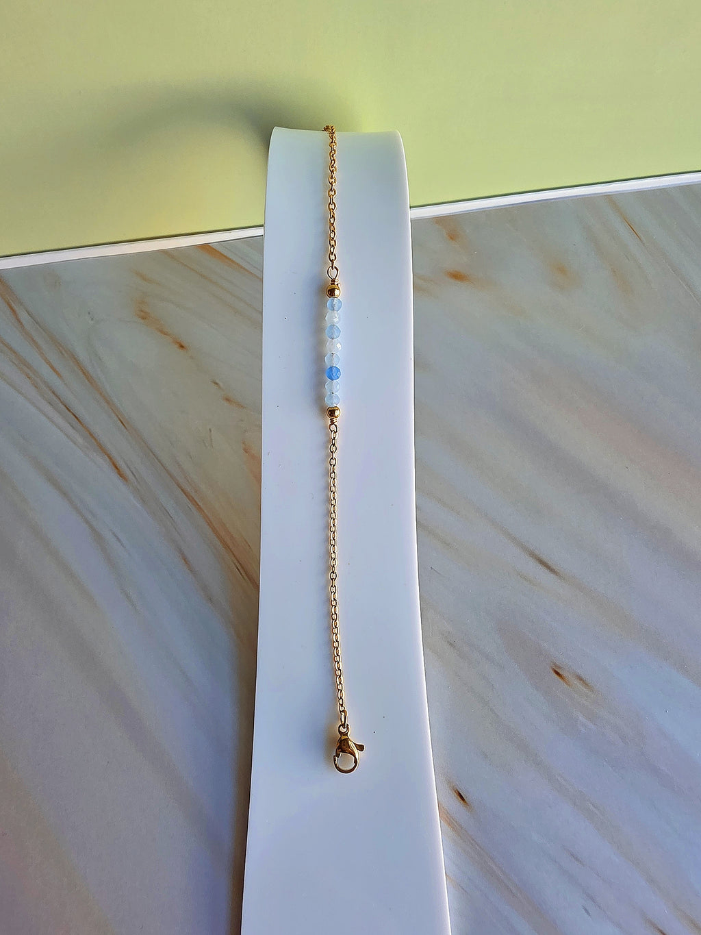 18K gold-plated gemstone bracelet available in Aquamarine, Emerald, or Moonstone.