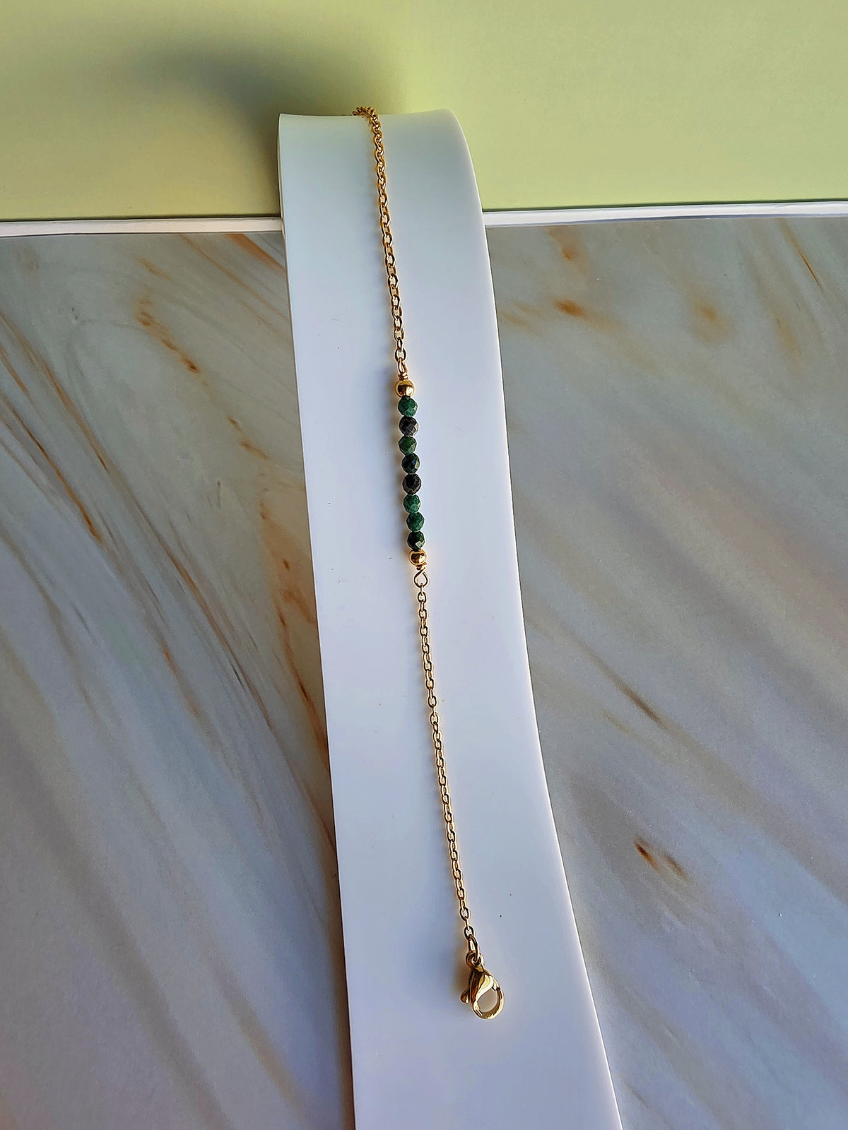 Beaded March birthstone bracelet with an adjustable gold-plated chain.