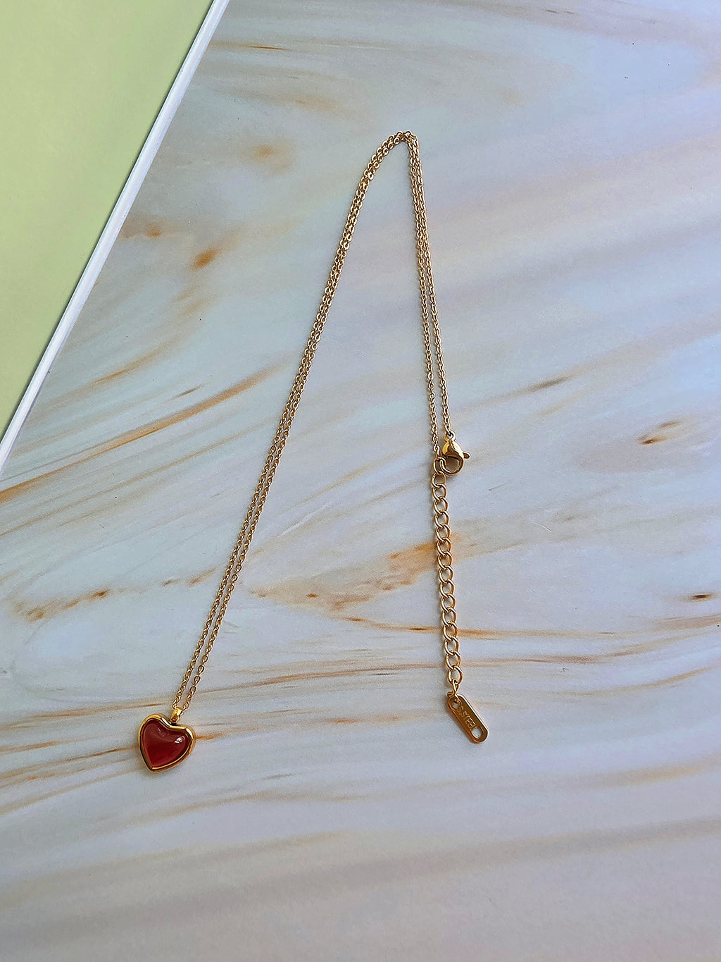 July birthstone necklace with a polished heart-shaped natural carnelian gemstone.