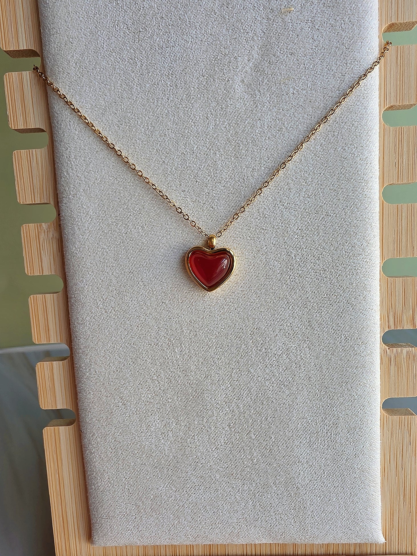 Women's waterproof crystal necklace featuring a vibrant red carnelian heart pendant.