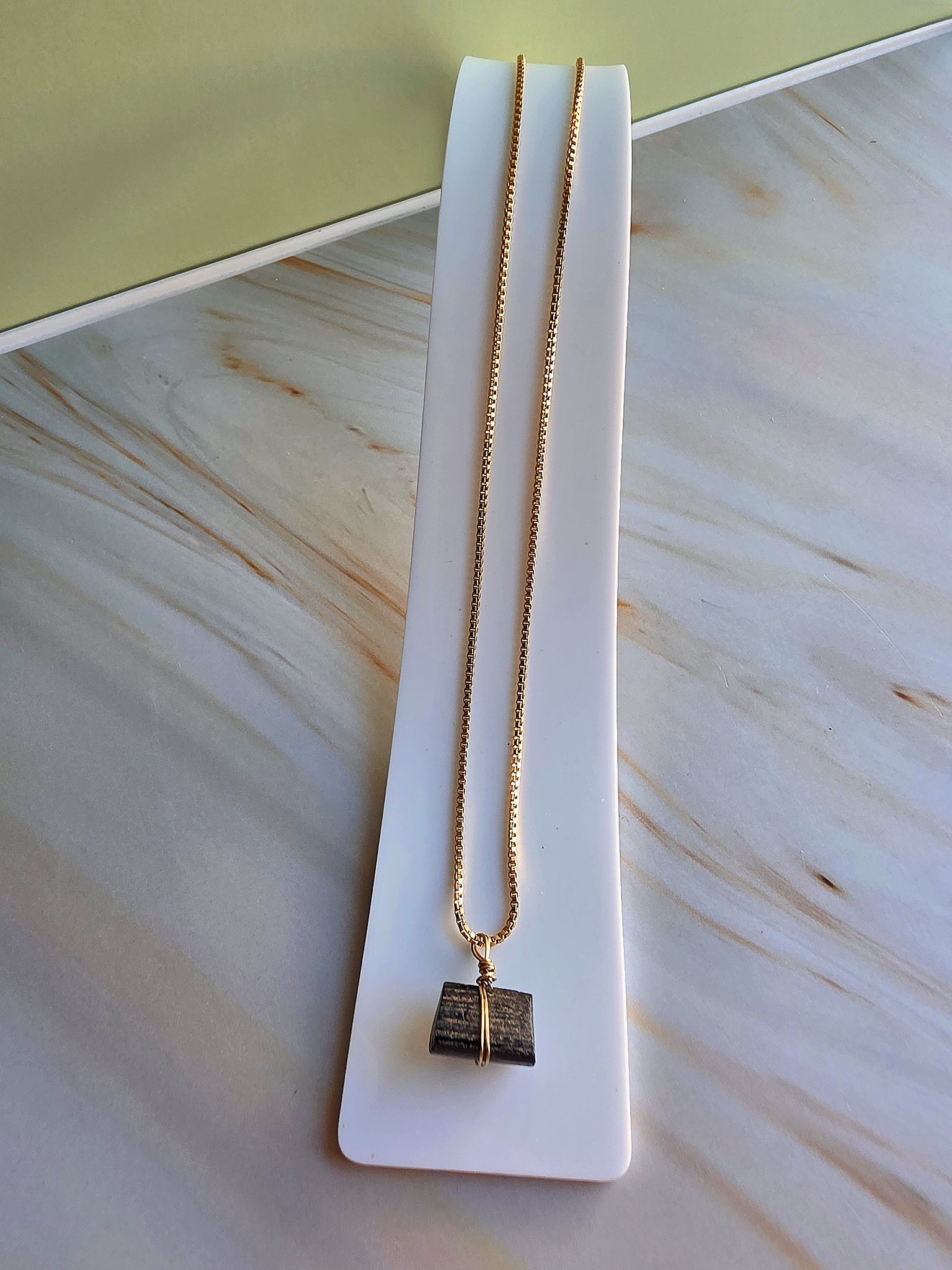 Raw crystal pendant necklace with natural black tourmaline and polished gold accents.