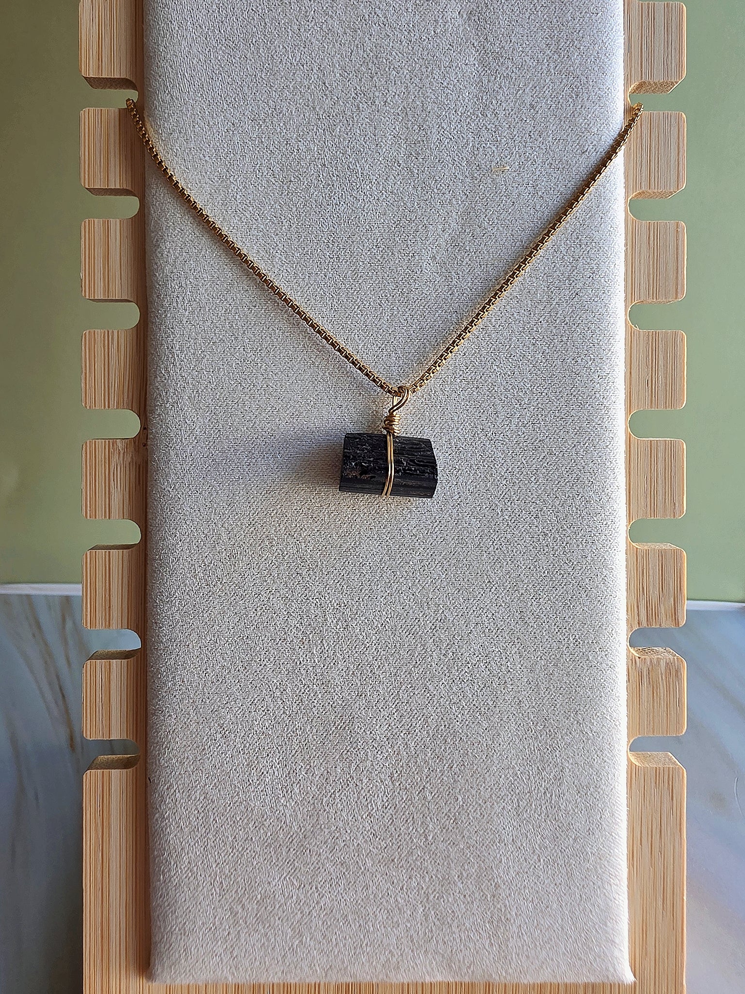 Genuine black tourmaline gemstone necklace featuring a minimalist gold-plated chain.