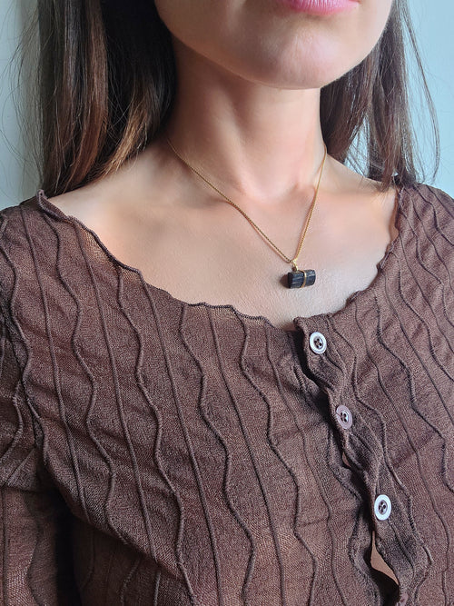 Natural black tourmaline crystal necklace with an elegant gold-plated finish.
