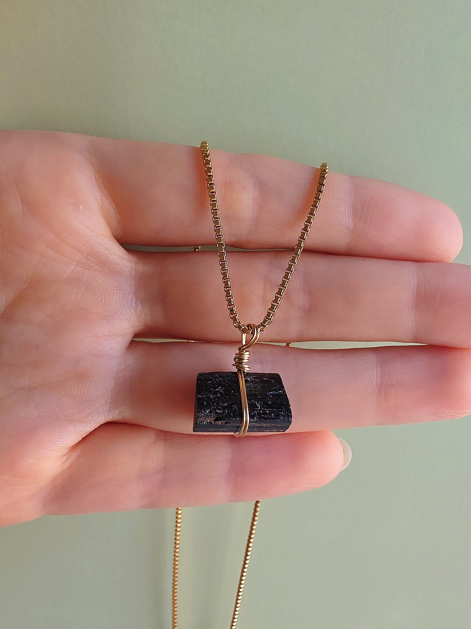 Women's raw black tourmaline pendant necklace for everyday wear and layering.