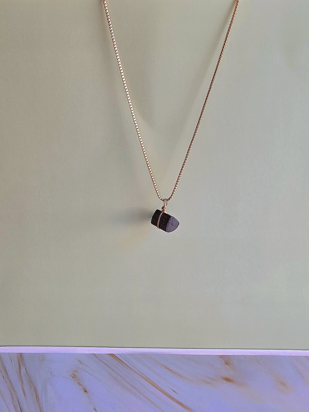 Minimalist black tourmaline pendant necklace, a thoughtful gift for women.