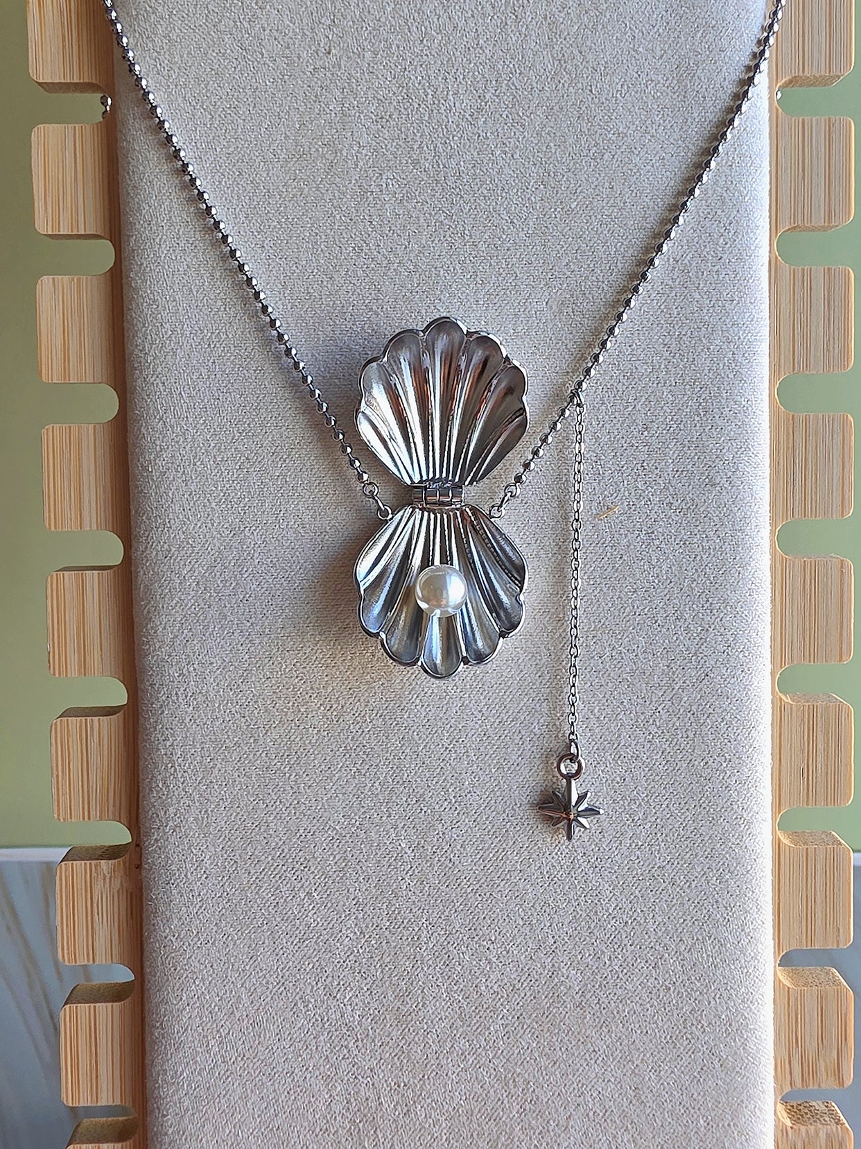 Ocean-inspired shell pendant necklace made from durable stainless steel.