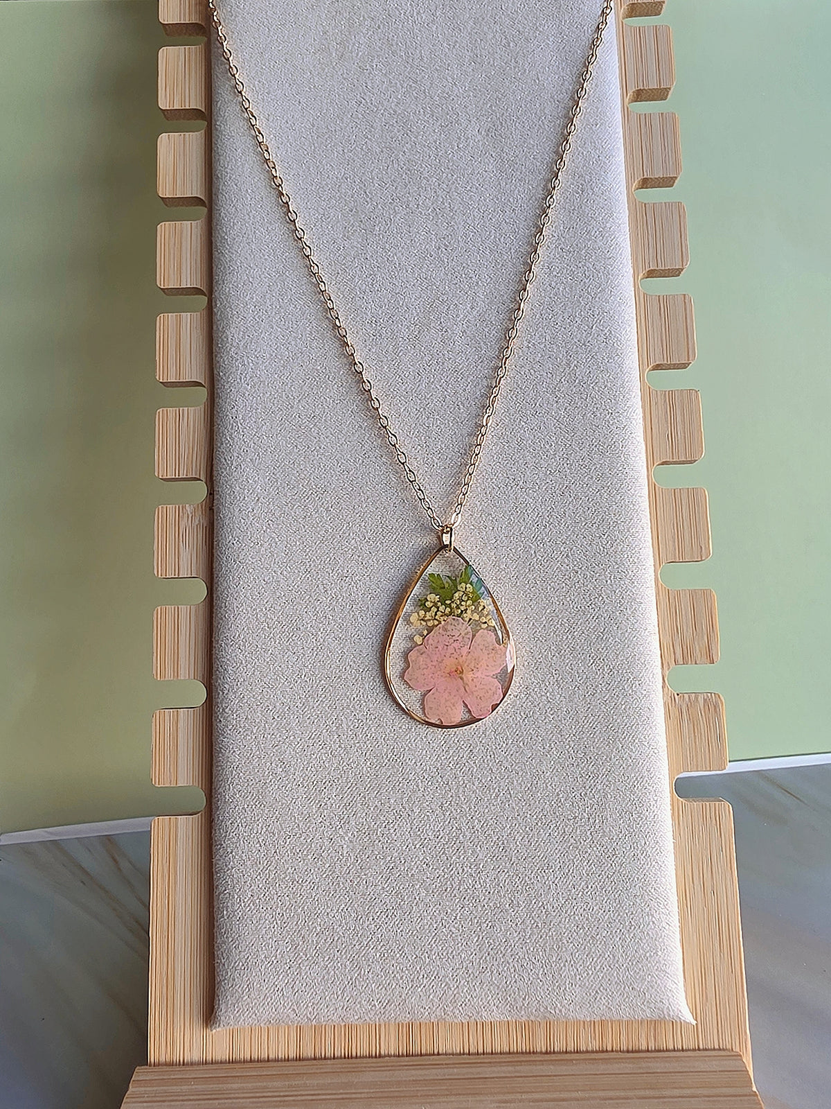 Dried flower resin necklace with 18K gold plating.