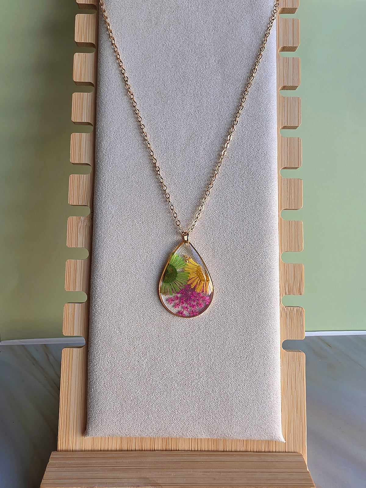 Floral resin necklace featuring genuine pressed flowers.