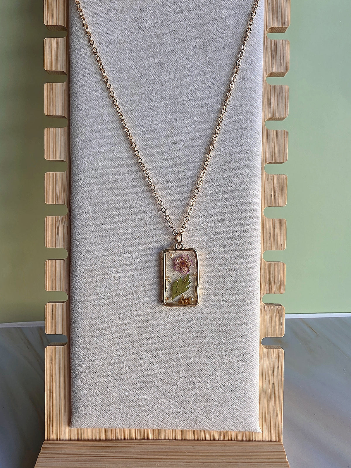 Nature-inspired botanical necklace with preserved blooms.