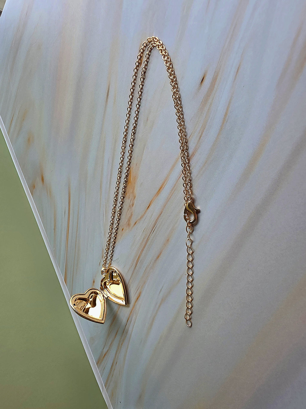 Handcrafted pressed flower necklace with a heart-shaped pendant.