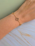 Adjustable four leaf clover bracelet with a polished 18K gold-plated chain.