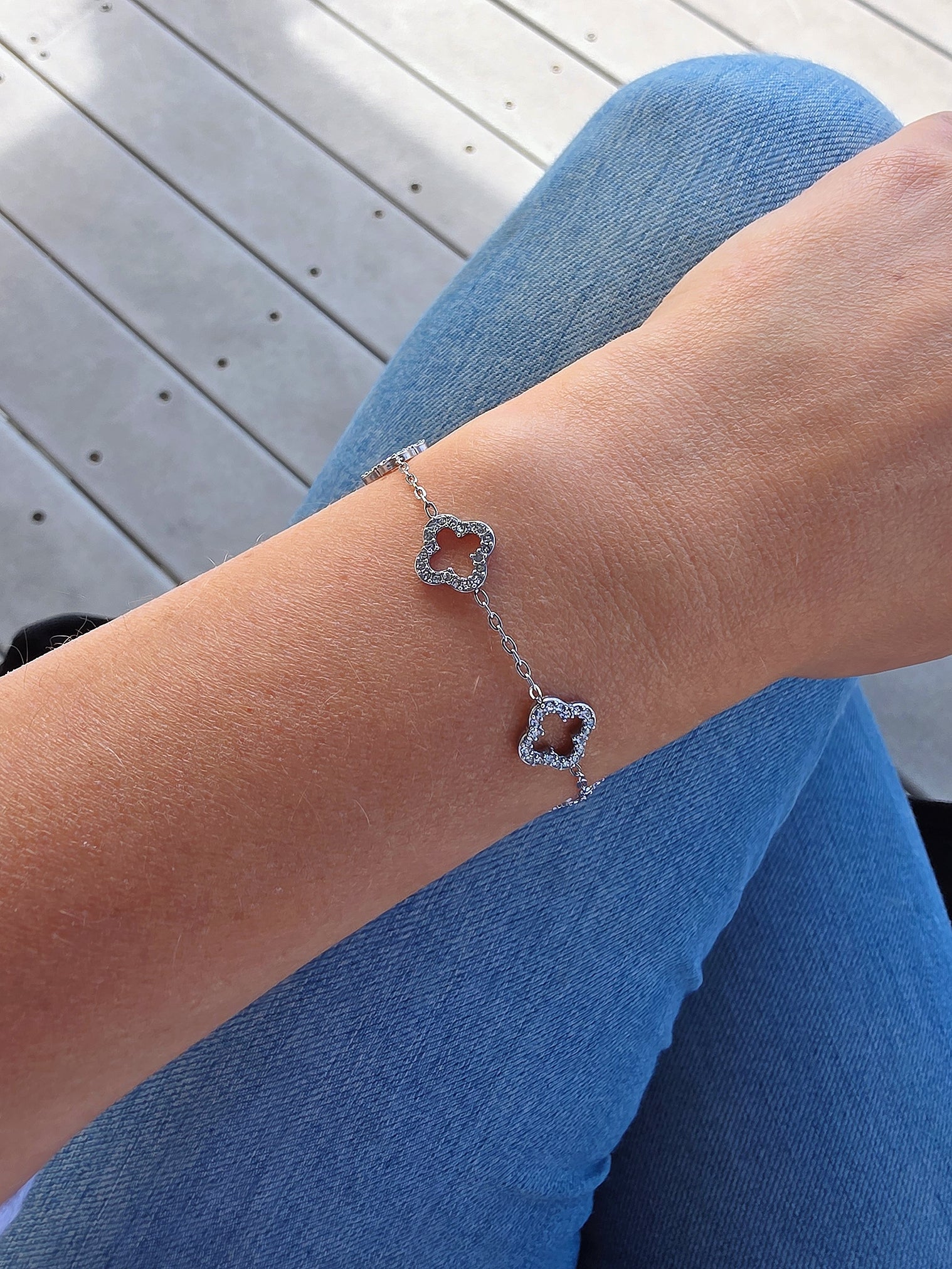 Gold-plated clover charm bracelet featuring a timeless lucky symbol.