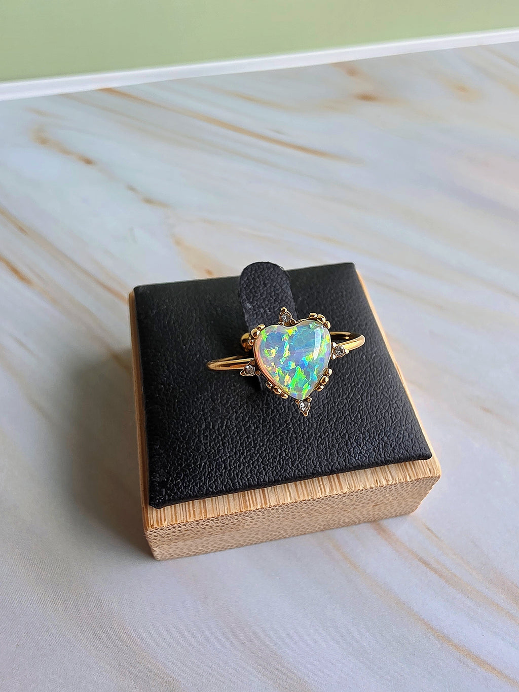 White fire opal rings with polished gold-plated settings and sparkling crystal accents.