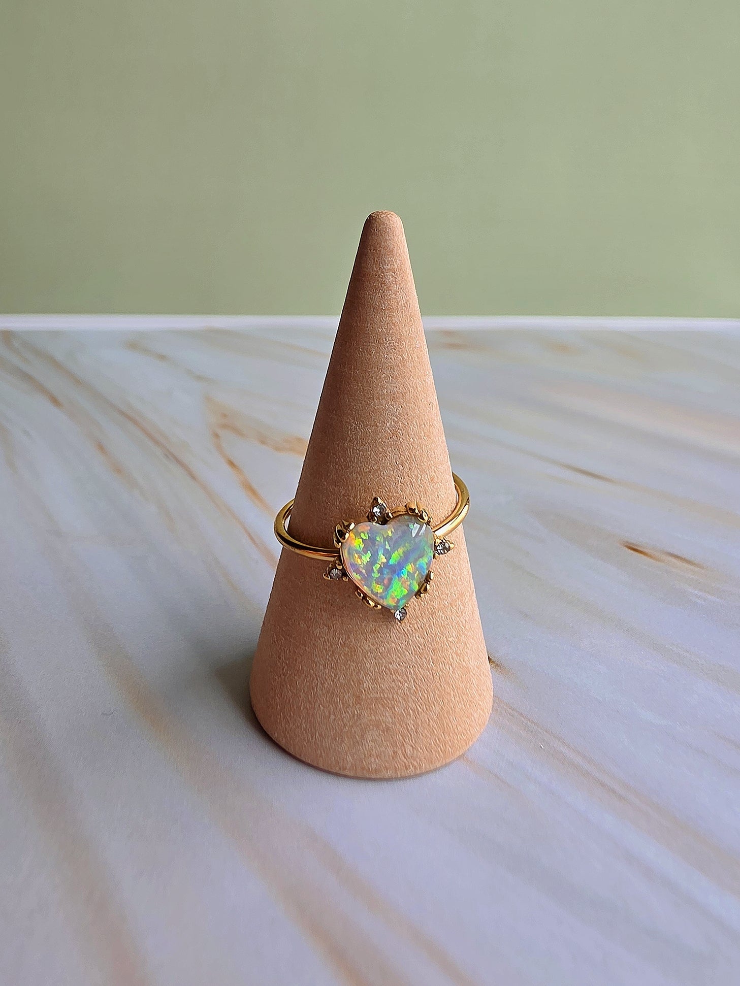 Adjustable sunflower and heart opal rings featuring radiant October birthstone opals.